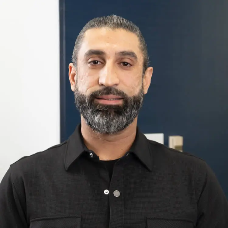 A man with a beard and mustache wearing a black shirt.